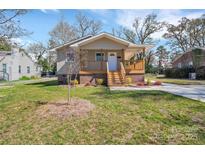 Charming one story home featuring a covered front porch, landscaped front yard and brick foundation at 647 Black E St, Rock Hill, SC 29730