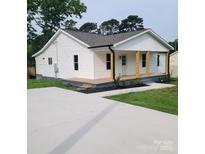 Charming single-story home featuring a welcoming front porch and a well-maintained lawn at 1018 Union St, Maiden, NC 28650
