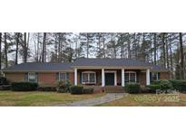 Charming brick home with a welcoming porch and well-maintained landscaping at 304 Taft St, Troy, NC 27371