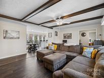Inviting living room features a comfortable sectional sofa, hardwood floors, and decorative ceiling beams at 33 Travora Cir, York, SC 29745