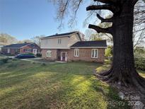 Charming brick home featuring a well-maintained lawn and mature trees for added shade and curb appeal at 3434 Fielding Ave, Charlotte, NC 28211