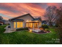 Beautiful backyard with a covered patio and lush green lawn perfect for outdoor relaxation and entertaining at 974 Platinum Dr, Fort Mill, SC 29708