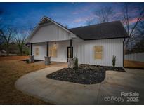 Charming exterior of a home showcasing stone columns and a well-manicured lawn at 1313 Gidney St, Shelby, NC 28150