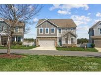 Charming two-story home with a gray shingle and stone facade, and a two-car garage at 138 Carolina Ash Ln, Mooresville, NC 28117