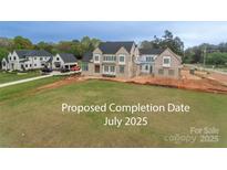 Under-construction exterior shows a light-brick two-story home on a spacious lot, part of a luxury community at 20310 Havenview Dr, Cornelius, NC 28031