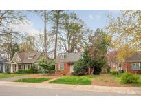 Charming brick home with dormer windows surrounded by mature trees and landscaping at 2508 Bay St, Charlotte, NC 28205