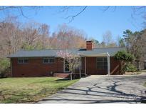 Charming brick ranch-style home with a covered driveway and well-maintained landscaping at 39058 Nc 740 Hwy, New London, NC 28127