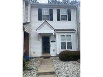 Charming townhome featuring classic black shutters and a well-maintained landscaped yard at 5650 Kimmerly Woods Dr, Charlotte, NC 28215