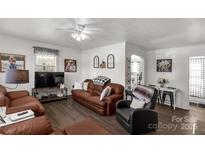 Cozy living room with modern brown leather sofas and a ceiling fan for added comfort at 727 Fickling Dr, Lancaster, SC 29720