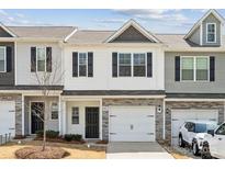 Charming two-story townhouse featuring a one-car garage and stone accents at 10036 Brittondale Ln, Charlotte, NC 28215