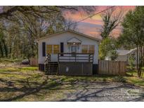 Charming single-story home with a welcoming front porch and a quaint, fenced yard at 115 Belton Ave, Mount Holly, NC 28120