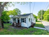 Charming cottage-style home with white siding, black shutters and a cozy front porch at 1413 Caldwell St, Gastonia, NC 28052