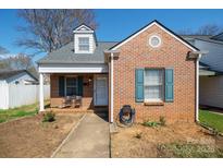 Charming brick home with a dormer window, blue shutters and covered front porch at 311 S Cedar St # C, Lincolnton, NC 28092