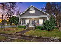 Charming renovated home with inviting front porch, manicured lawn, and classic architectural details at 329 N Ellis St, Salisbury, NC 28144