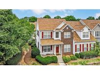 Charming two-story home with brick accents, red shutters, and a cozy front porch at 4818 Grier Farm Ln, Charlotte, NC 28270