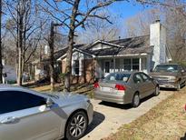 Charming single-Gathering home with a brick and vinyl exterior, a well-maintained lawn, and a private driveway for parking at 6536 Pineburr Rd, Charlotte, NC 28211
