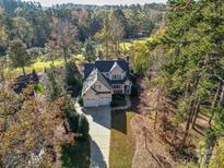 Stunning aerial view of a two-story home with a well-manicured yard surrounded by lush trees at 124 Gatlin Knl # 11, New London, NC 28127