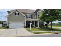 Charming two-story home with a well-manicured lawn and inviting curb appeal with attached garage at 1501 Allegheny Way, Waxhaw, NC 28173