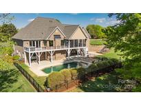 Stunning backyard with private pool, screened-in porch, and lush landscaping at 341 Canvasback Rd, Mooresville, NC 28117