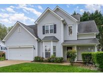 Charming two-story home with vinyl siding, attached garage, and well-manicured lawn, perfect for suburban living at 3905 Farlow Rd, Charlotte, NC 28269