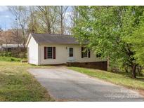 Charming one-story home with a driveway and mature trees, offering a peaceful setting at 410 E Lee Ave, Bessemer City, NC 28016