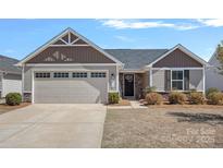 Charming one-story home with a well-manicured lawn and attached two-car garage at 4318 Greenleaf Nw St, Concord, NC 28027