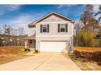 Inviting two-story home boasts a well-maintained lawn and an attached two-car garage at 4852 Stone Dr, Conover, NC 28613