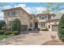 Stunning stucco home with a brick driveway and well-manicured landscaping at 7308 Amberwood Ct, Charlotte, NC 28226