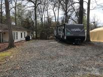 RV with gravel space and a small yard perfect for camping at 137 Landlubber Trl, Mount Gilead, NC 27306