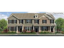 Charming townhome showcasing a beautiful facade and well-manicured landscaping at 2052 Harlequin Dr, Indian Trail, NC 28079