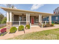Charming home featuring a welcoming front porch with stone accents and a bright red door at 232 Cromer St, Charlotte, NC 28208