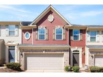 Charming townhome featuring a red facade, brick accents, and a two-car garage at 2446 Alyssa Ln, Charlotte, NC 28208