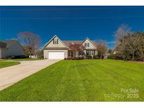 Charming two-story home with a well-manicured lawn and inviting curb appeal on a sunny day at 282 W Shiloh Unity Rd, Lancaster, SC 29720