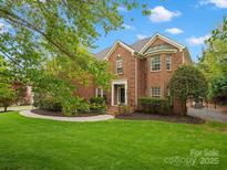 Beautiful brick home with a well-manicured lawn and lush landscaping at 3100 Stanway Ct, Waxhaw, NC 28173
