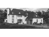 Elegant two-story house with lush landscaping, attached two-car garage, and traditional architectural style at 3212 Willow Oak Rd, Charlotte, NC 28209