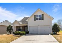 Charming two-story home with a two-car garage, well-manicured lawn, and inviting curb appeal under a clear, blue sky at 3908 Parkers Ferry Rd, Fort Mill, SC 29715