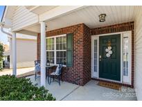Charming front porch with brick accents, a cozy seating area, and a welcoming entrance to the home at 3908 Parkers Ferry Rd, Fort Mill, SC 29715