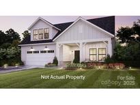 Charming two-story home with manicured lawn, inviting front porch, and attached garage at 8135 Stillhouse Ln # 28, Harrisburg, NC 28075