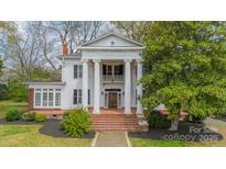 Stately white home featuring grand columns, a brick staircase, and a well-manicured front yard at 8425 E Franklin St, Mount Pleasant, NC 28124