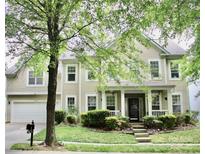 Charming two-story home featuring a manicured lawn and a welcoming front porch at 13127 Centennial Commons Pkwy, Huntersville, NC 28078
