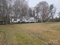 Charming single-story home with neutral siding, dark shutters, and a well-maintained front lawn at 1608 Waxhaw Indian Trail Rd, Indian Trail, NC 28079