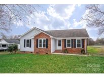 Charming single-story home featuring a brick facade, black shutters, and a well-maintained front lawn at 3001 Austin Chaney Rd, Monroe, NC 28110