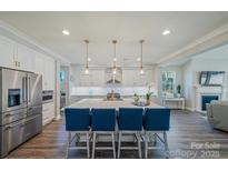 Spacious kitchen featuring a large island with seating, stainless steel appliances, and ample cabinet space at 6398 Chimney Bluff Rd, Lancaster, SC 29720