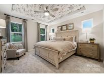 This bedroom features a decorative ceiling and a large bed flanked by matching nightstands at 8654 Miles Gap Rd, Indian Land, SC 29707