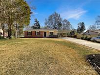 Charming single-story home with brick accents, carport, and a well-manicured lawn at 11712 Battery Pl, Charlotte, NC 28273