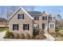 Charming brick home with black shutters, manicured landscaping, and a welcoming entrance at 2017 Belle Grove Dr, Waxhaw, NC 28173