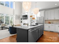 Modern kitchen featuring a large island, stainless steel appliances, and hardwood floors that blend style with functionality at 415 Spring St, Davidson, NC 28036