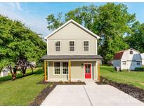 Charming two-story home with a bright red front door, inviting curb appeal and well-manicured landscaping at 570 Key West Ave, Kannapolis, NC 28081