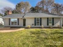 Charming single-story home featuring a well-maintained lawn and classic architectural details at 10707 Copper Field Dr, Pineville, NC 28134