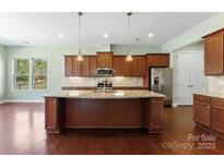 Island kitchen featuring granite countertops, stainless steel appliances, and ample cabinet space at 11037 Thornbeck Ln, Midland, NC 28107